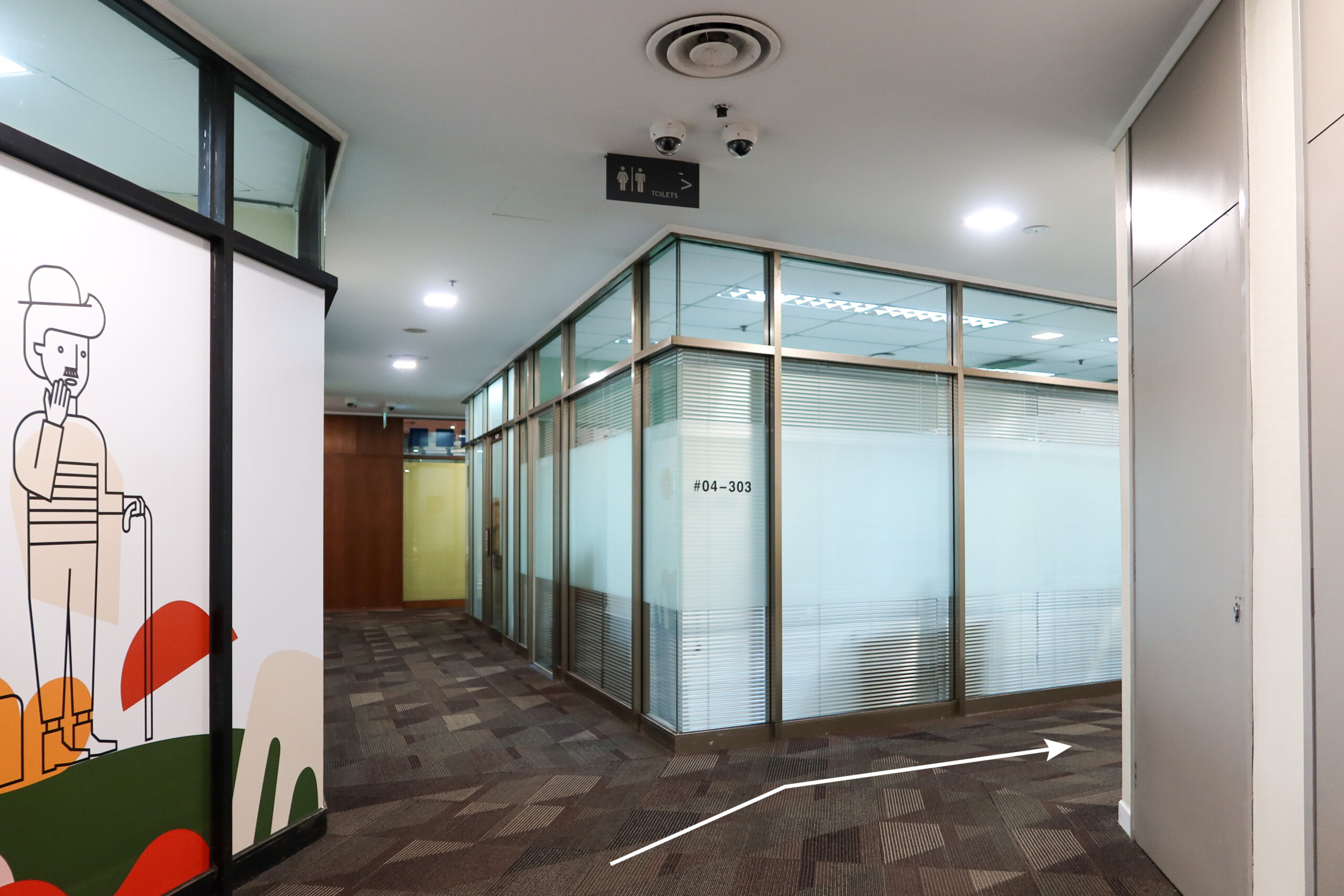 Turn right and follow the signage towards the bathrooms. Turn left at the end of the hall.