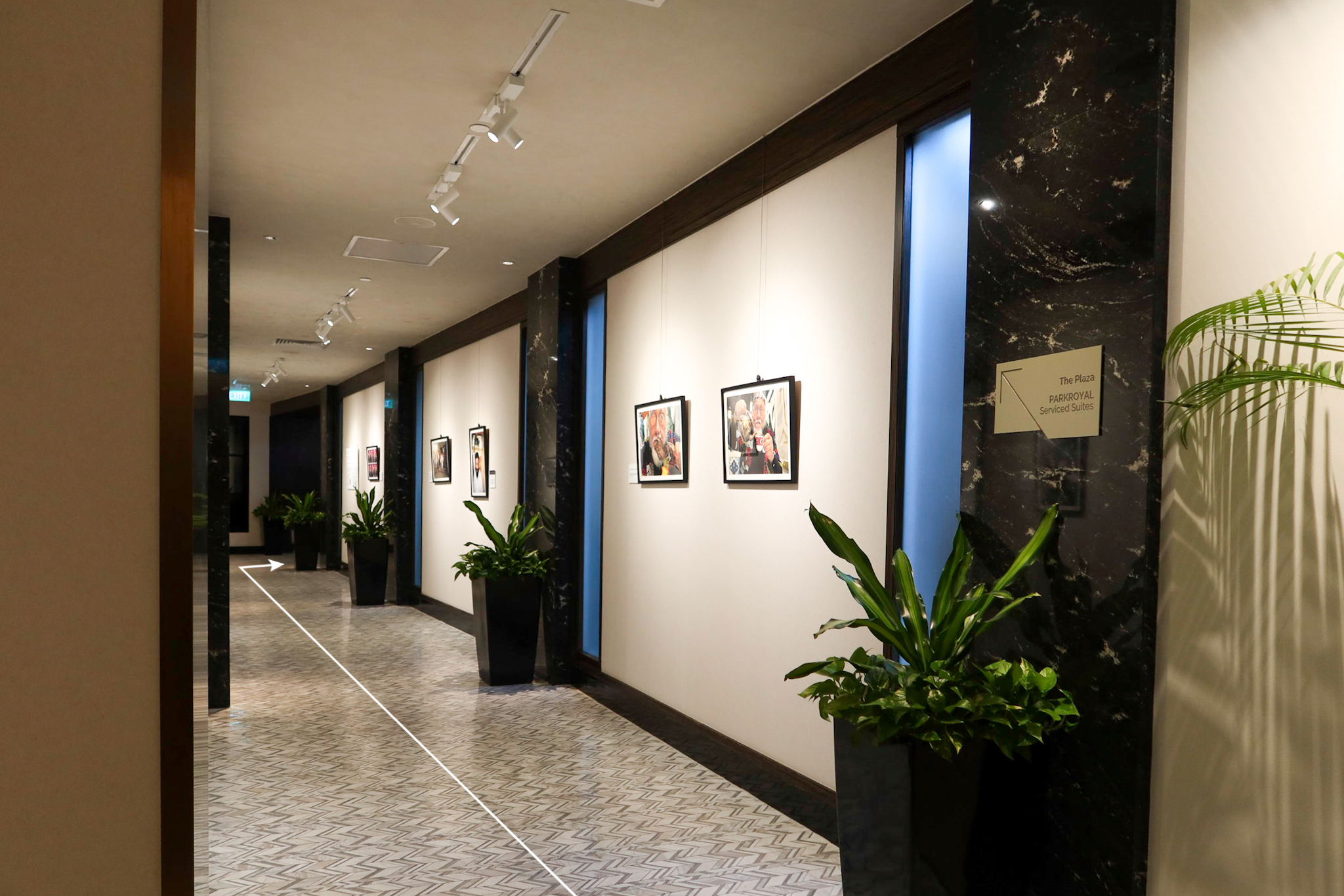 Turn left once you arrive outside the restaurant and walk along the passageway with art hanging on both walls.